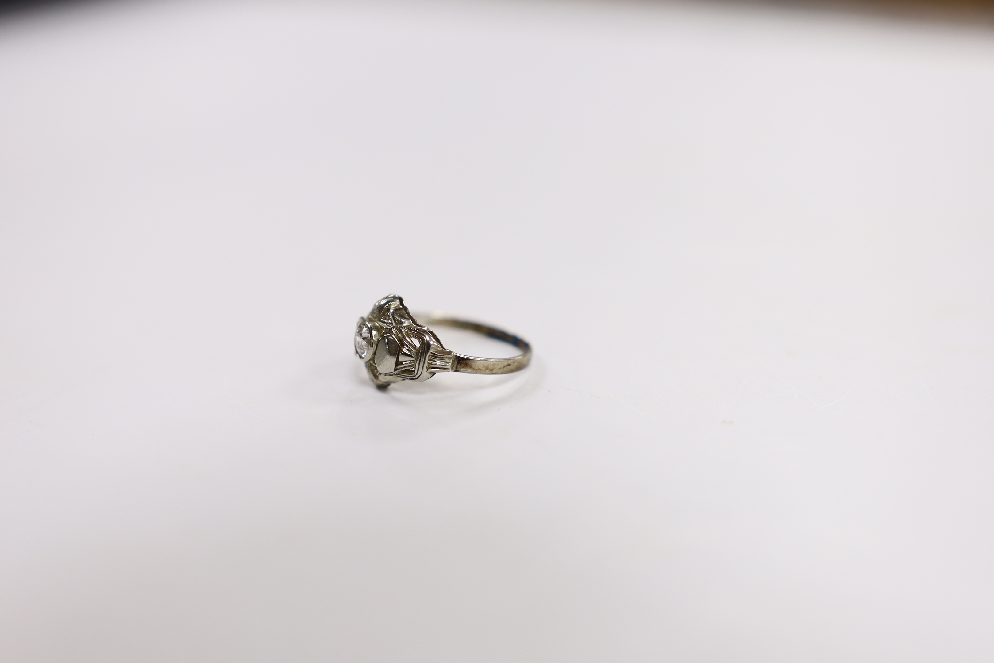 A 750 white metal and collet set solitaire diamond ring, size L, gross weight 1.5 grams.